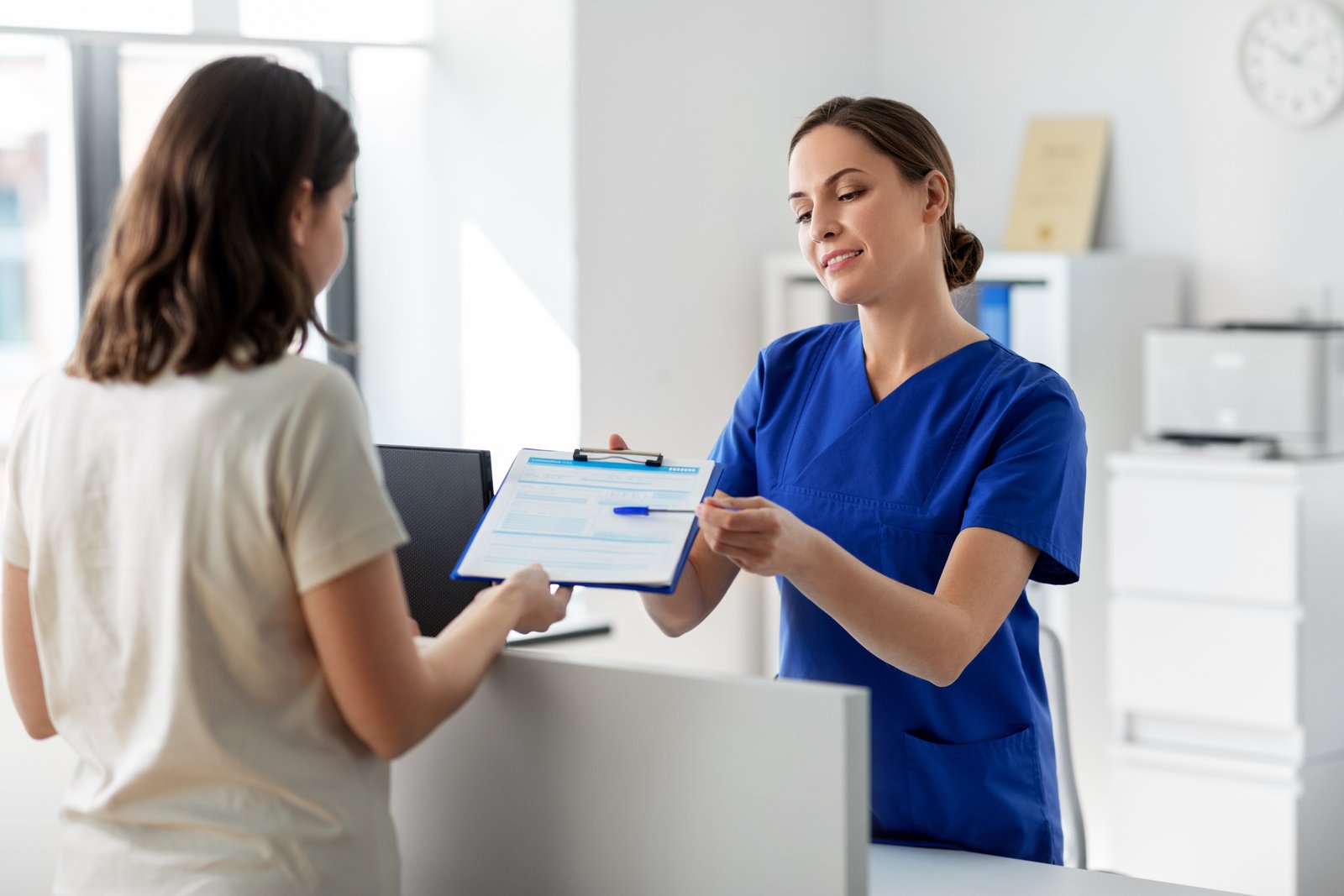 doctor with clipboard and patient at hospital
